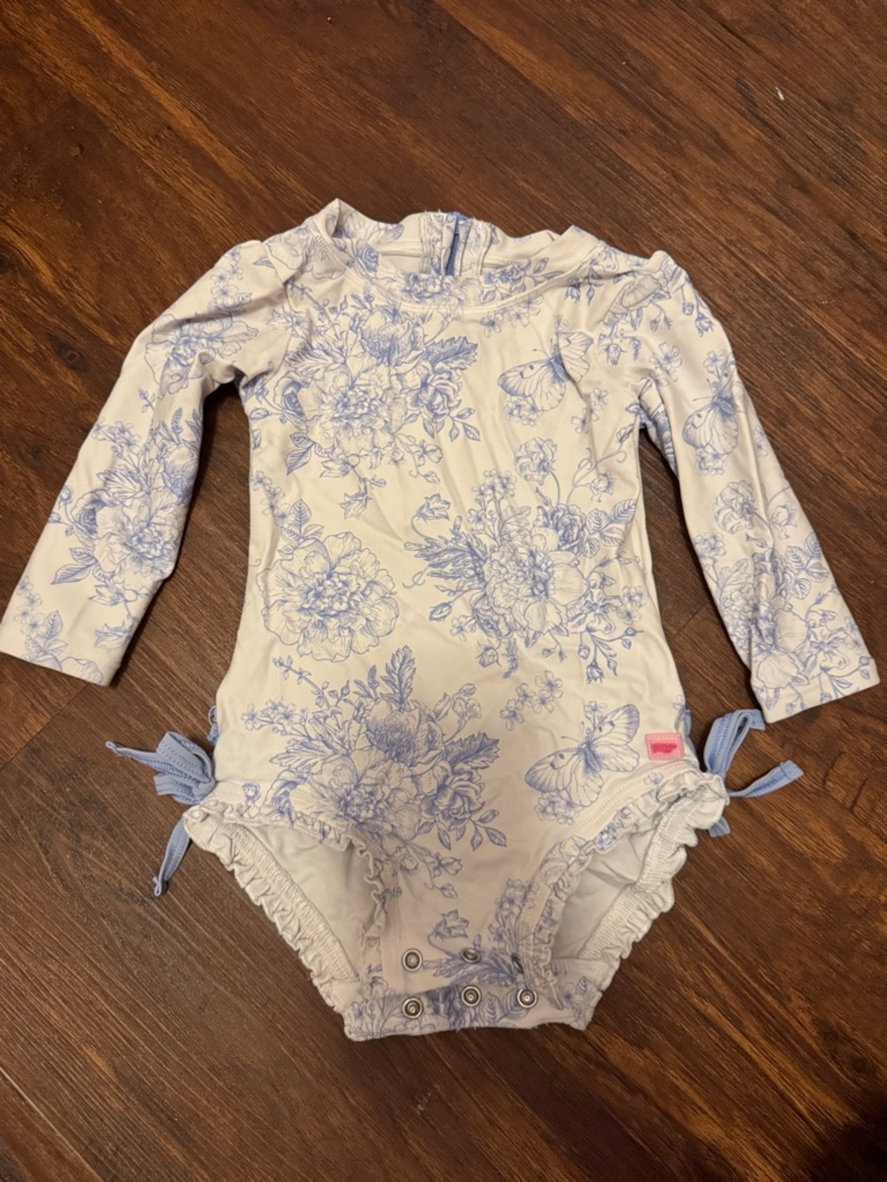 Ruffle Butts Cream One-Piece with Blue Floral Print